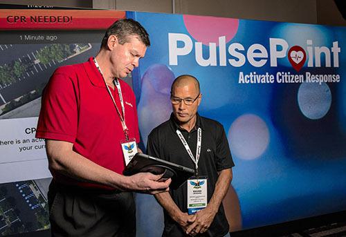 Discussing PulsePoint at a trade show booth.